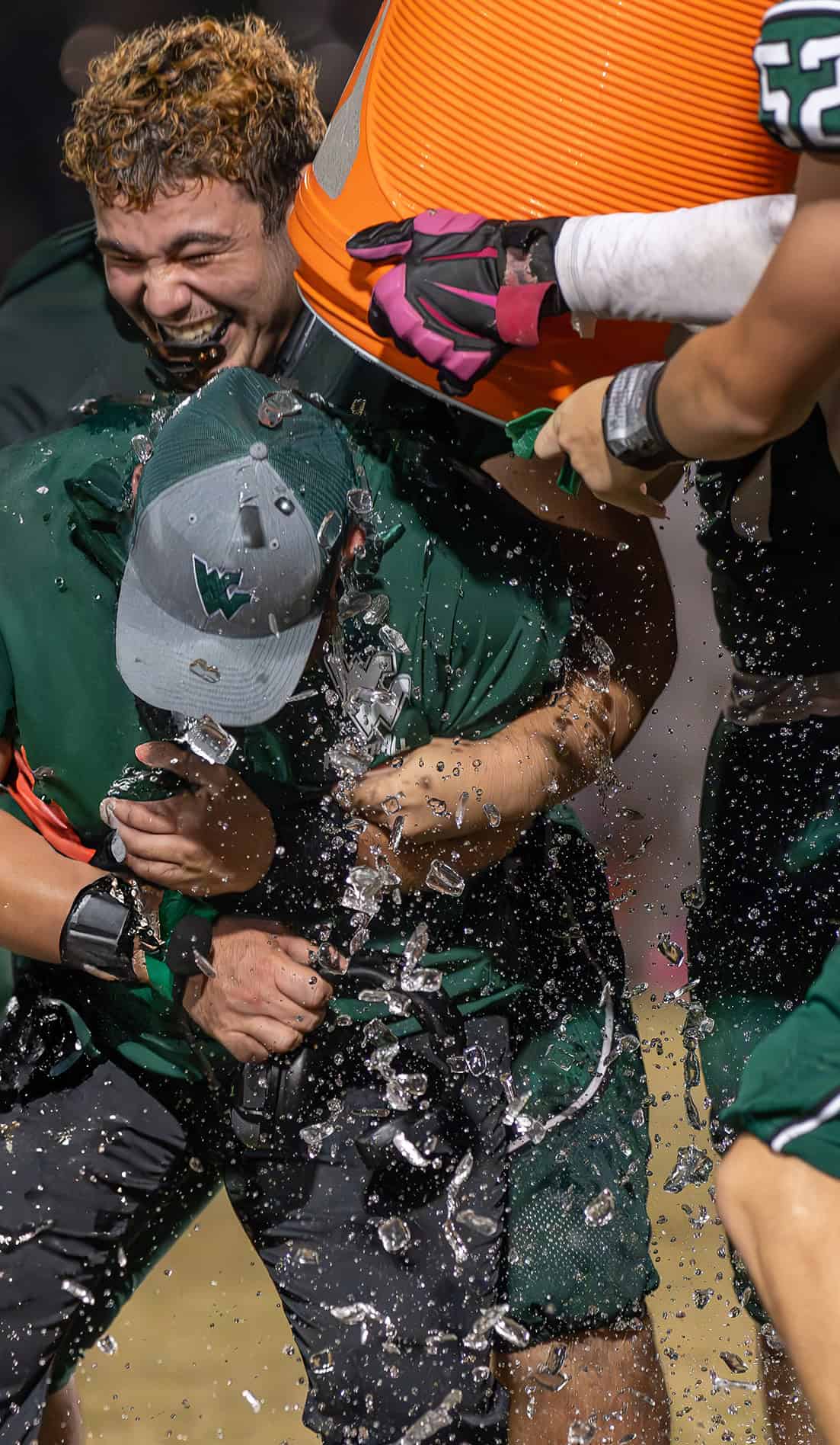 Weeki Wachee High Head Coach, Justin Bland gets the ice bath after beating visiting Hernando High. [Photo by Joe DiCristofalo]