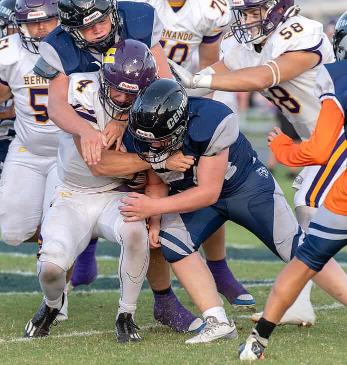 Central High's, 9, Kolby Zwaan and, 54, Conner Oudeans combine to wrap up Hernando High QB, 4, Michael Saltsman. [Photo by Joe DiCristofalo]