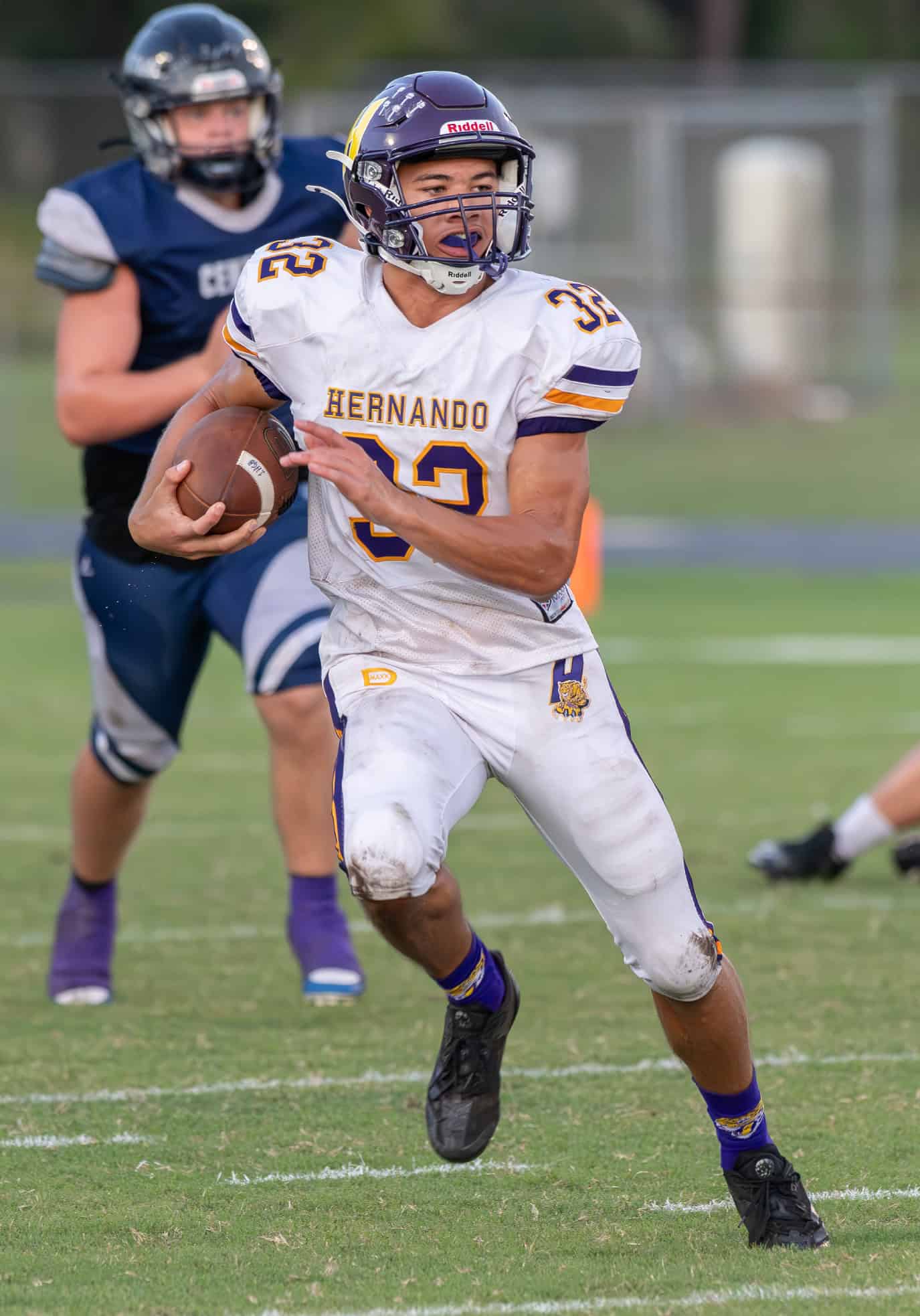 Hernando High, 32,  Stevontae Hasberry rips off a big gain Monday night at Central High. [Photo by Joseph DiCristofalo]