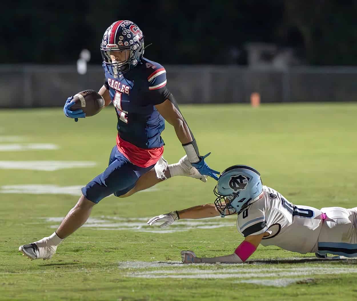 Springstead, 4, Connor McCazzio eludes the tackle attempt by Nature Coast Tech, 0, Cashis Williams Friday at Booster Stadium. [Photo by Joseph DiCristofalo]