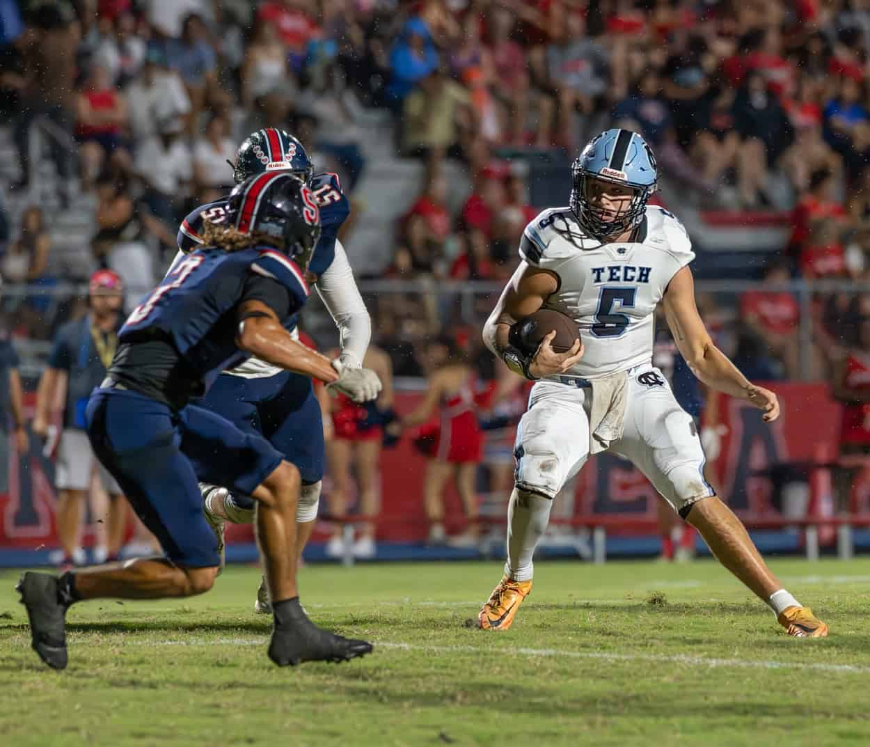 Nature Coast Tech, 5, Jackson Hoyt takes on a Springstead tackler at Booster Stadium. [Photo by Joseph DiCristofalo]