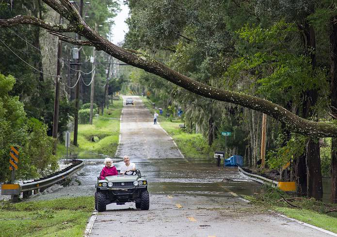 Carolyn and Roy Clardy driving away from flooding in Old Crystal River Road in Brooksville, Fla., on Thursday, October 10, 2024. [Photo by Hanna Maglio]