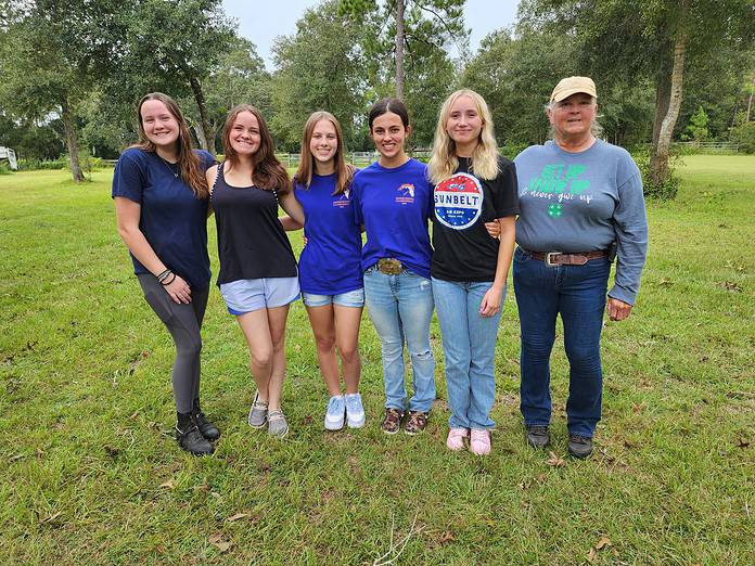 (Left to right) 4-H members Eliana Snodgrass, Megan Watier, Kaylie Michot, Delaney Sheldon, and Layla DelVecchio are mentored by club leader Dorothy Blair (right). [Photo provided]