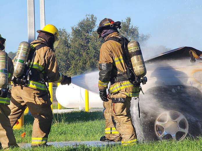 Cadets demonstrate their fire fighting techniques at Monday's grand opening. [Credit: Austyn Szempruch]