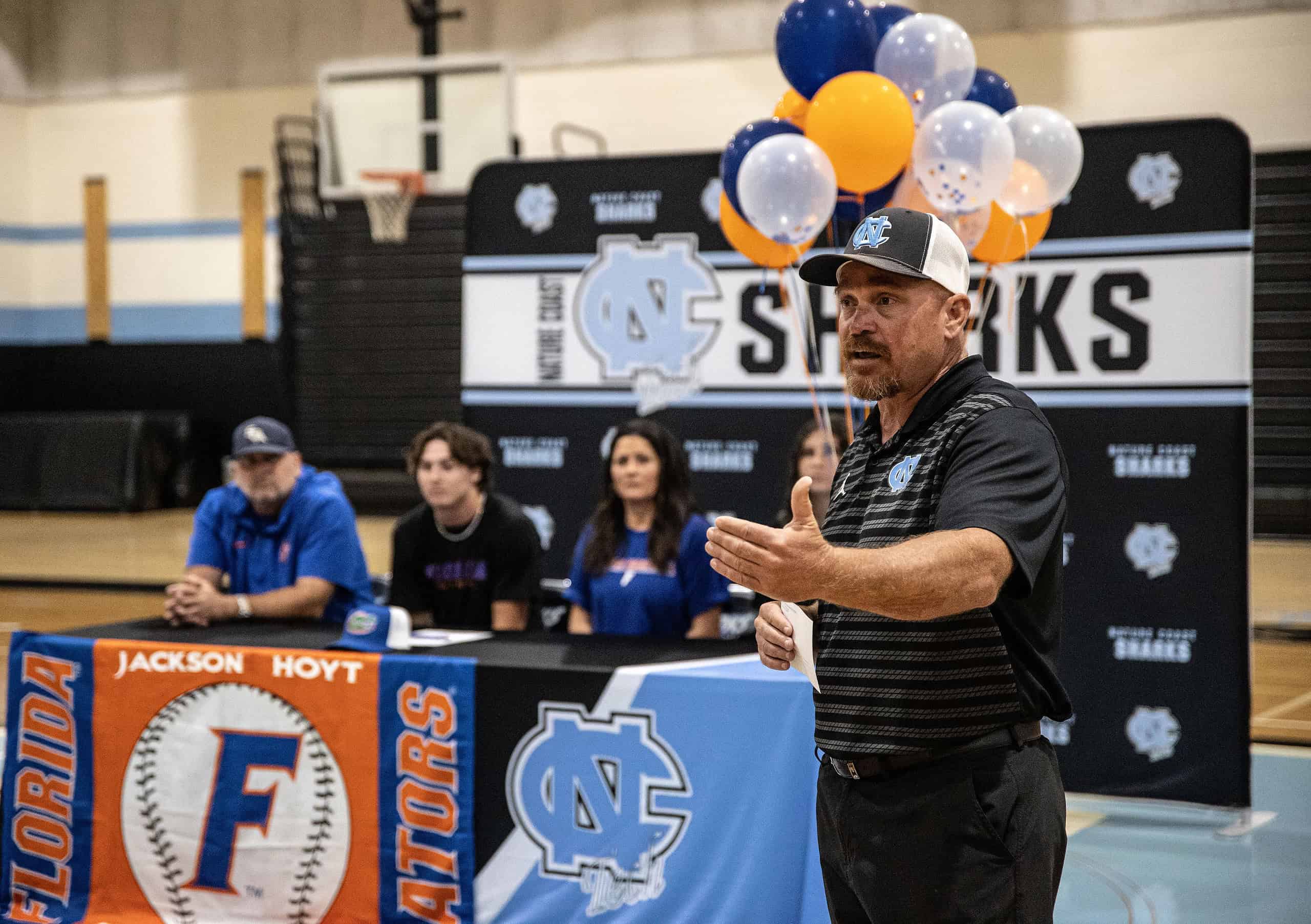 Nature Coast baseball coach Dan Garofano with the Hoyt family in the background. [Photo by Austen Aupperlee]