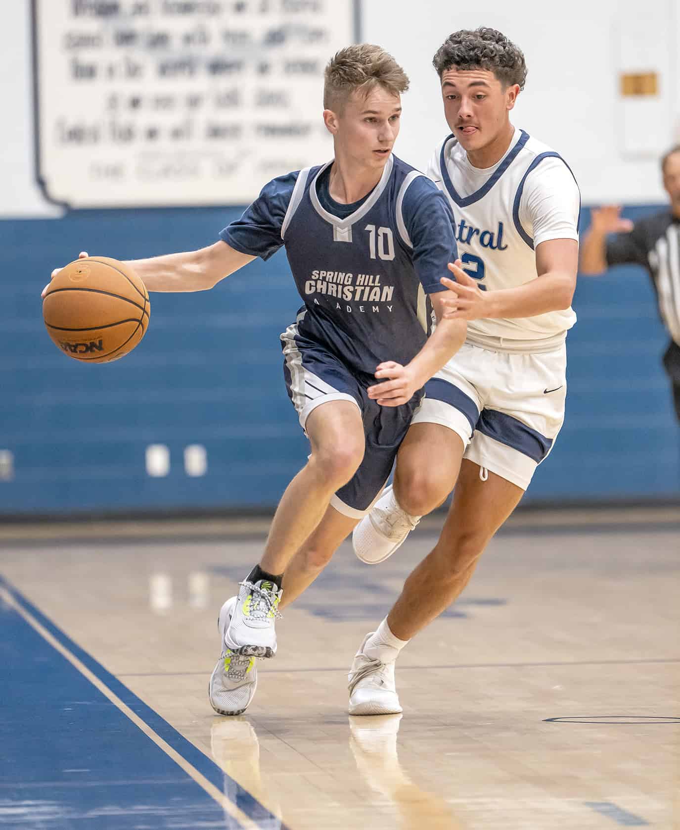 Spring Hill Christian Academy, 10, Isaac Johnston brings the ball up court past the defense by Central High,12, Alvin Cortez. [Photo by Joe DiCristofalo]