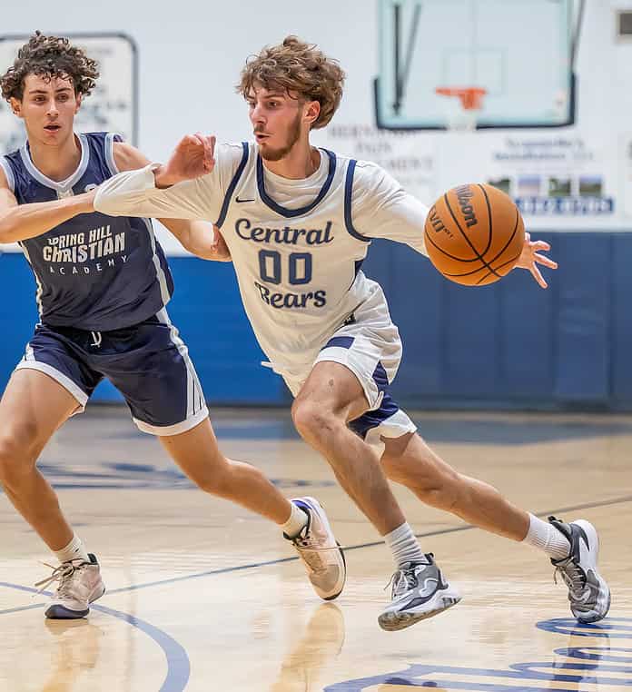 Central High, 00, Brayden Prospero drives the baseline while defended by Spring Hill Christian Academy, 25, Matthew Hyde. [Photo by Joe DiCristofalo]