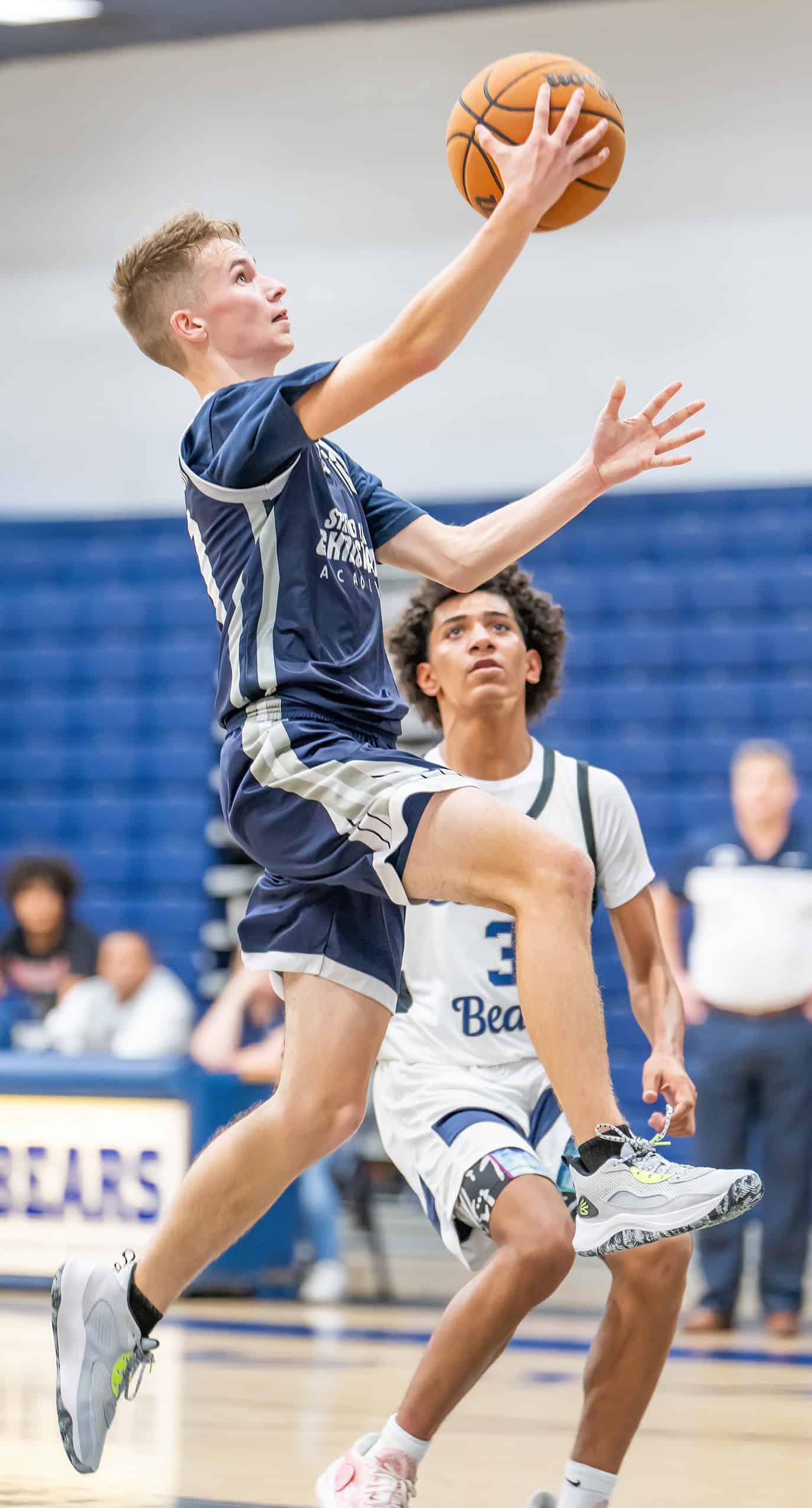 Spring Hill Christian Academy, 10, Isaac Johnston elevates for a layup defended by Central High, 3, Marcelo Fonseca. [Photo by Joe DiCristofalo]