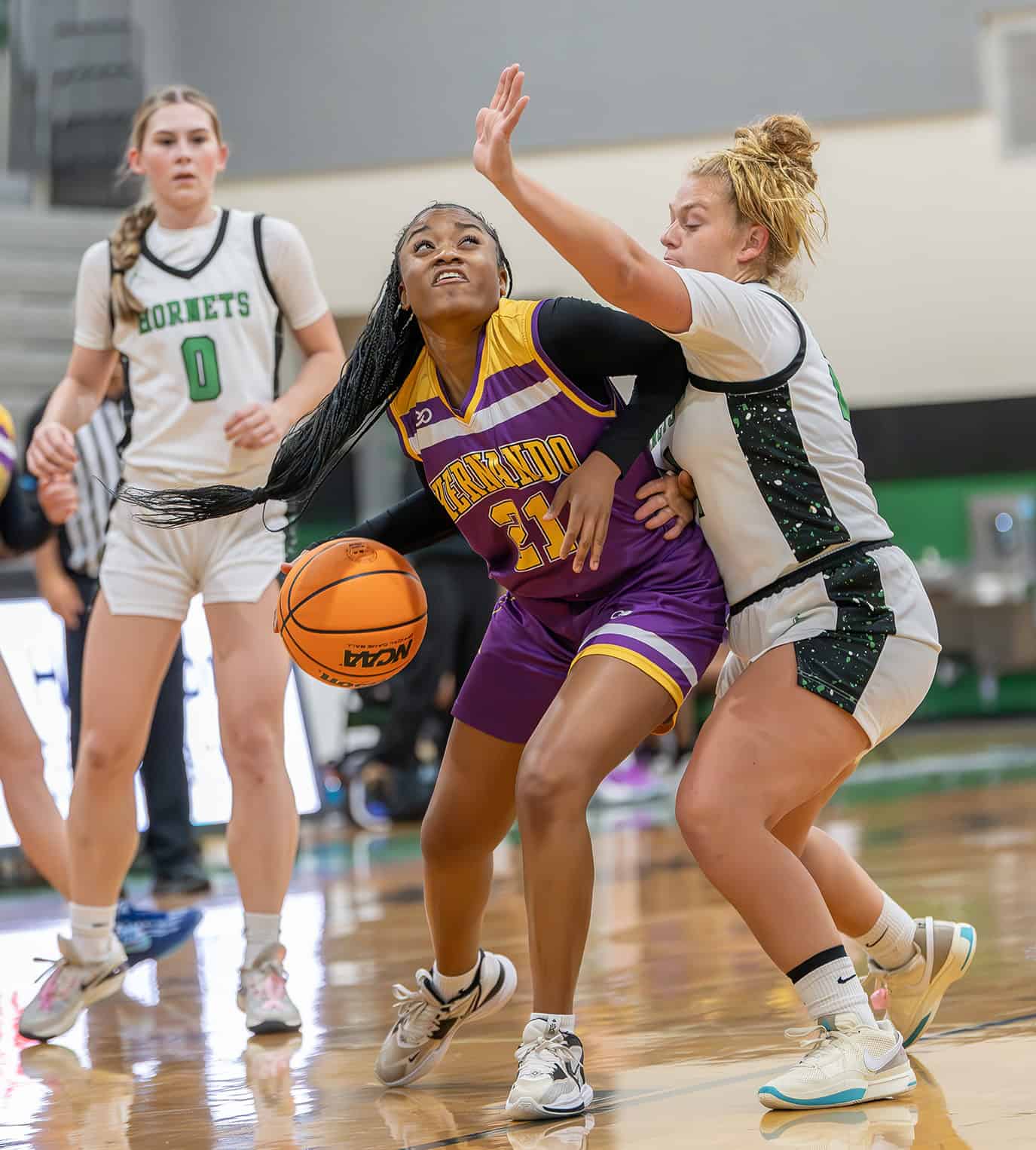 Hernando High, 21, Tyrah Gary eyes the basket while guarded by Weeki Wachee, 24, Karly Pasmore Friday at Weeki Wachee High. [Photo by Joe DiCristofalo]