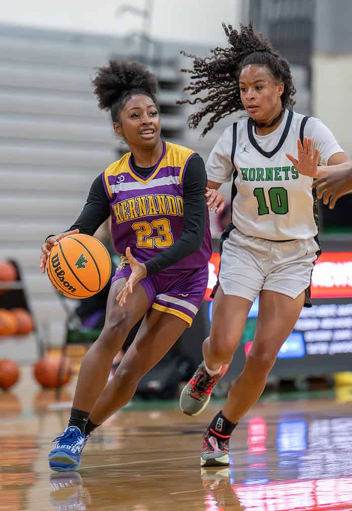 Hernando High, 23, Ayana Kincade works past Weeki Wachee, 10, Genesis Beal Friday at Weeki Wachee High. [Photo by Joe DiCristofalo]