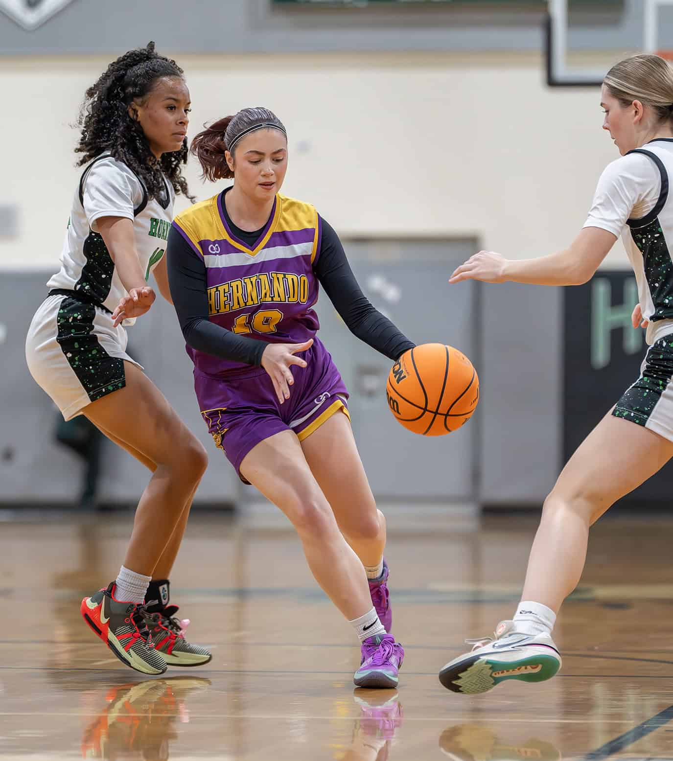 Hernando High, 10, Savannah Condron attempts to split the defense by Weeki Wachee, 10, Genesis Beal and Reese Halter Friday at Weeki Wachee High. [Photo by Joe DiCristofalo]