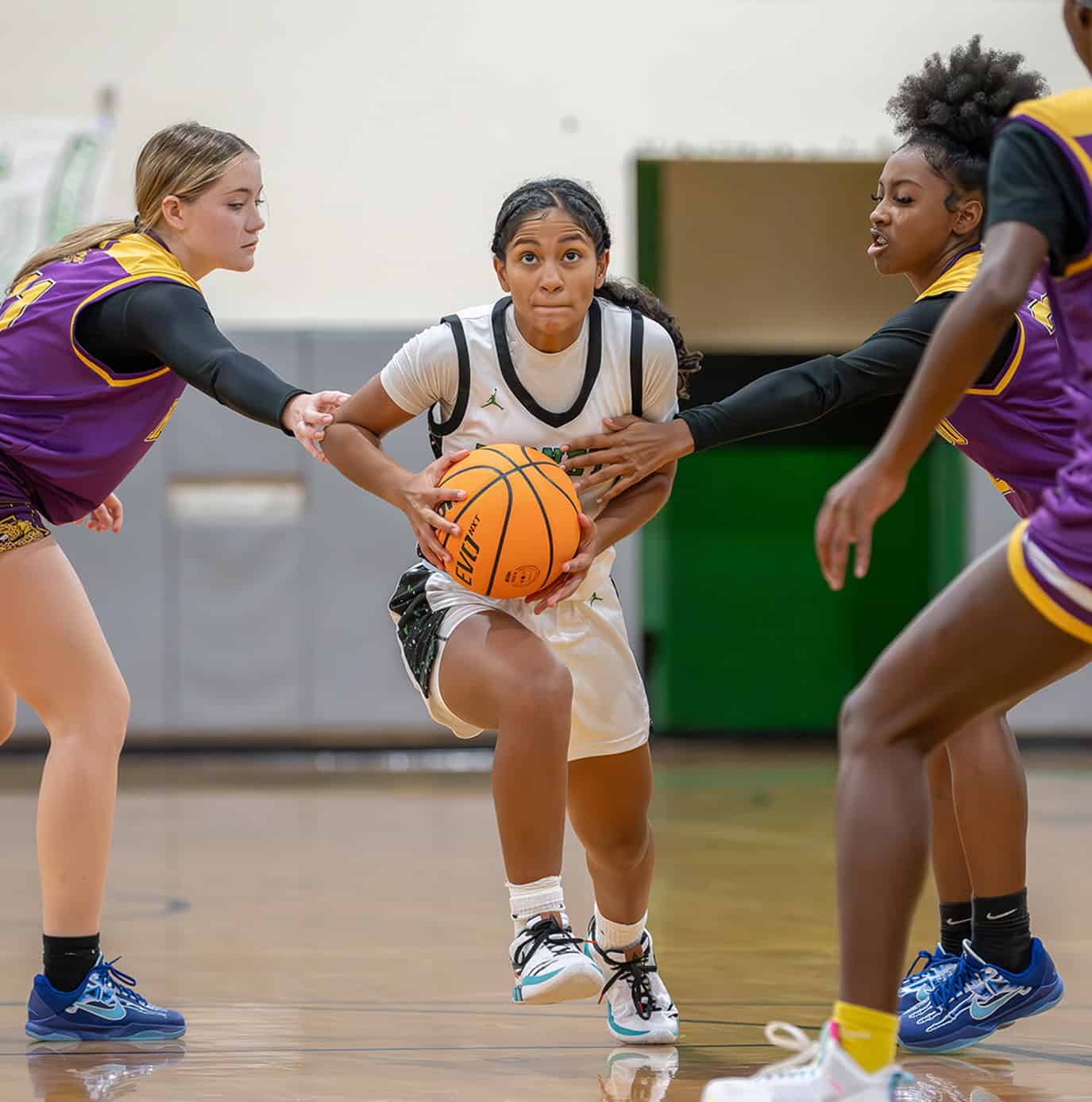 Weeki Wachee, 3, Joelys Rodriguez has her progress interrupted by Hernando High Aislin Ruppe and Tamia Williams. [Photo by Joe DiCristofalo]