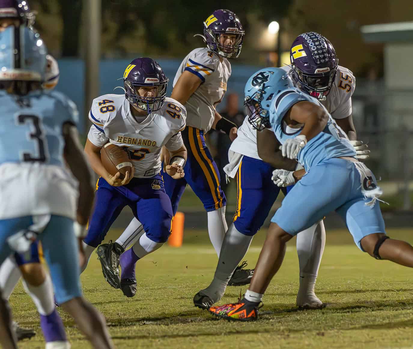 Hernando High, 48, Mason Pauliot follows the block by ,55, Noah Brown in the game at Nature Coast Tech. [Photo by Joe DiCristofalo]