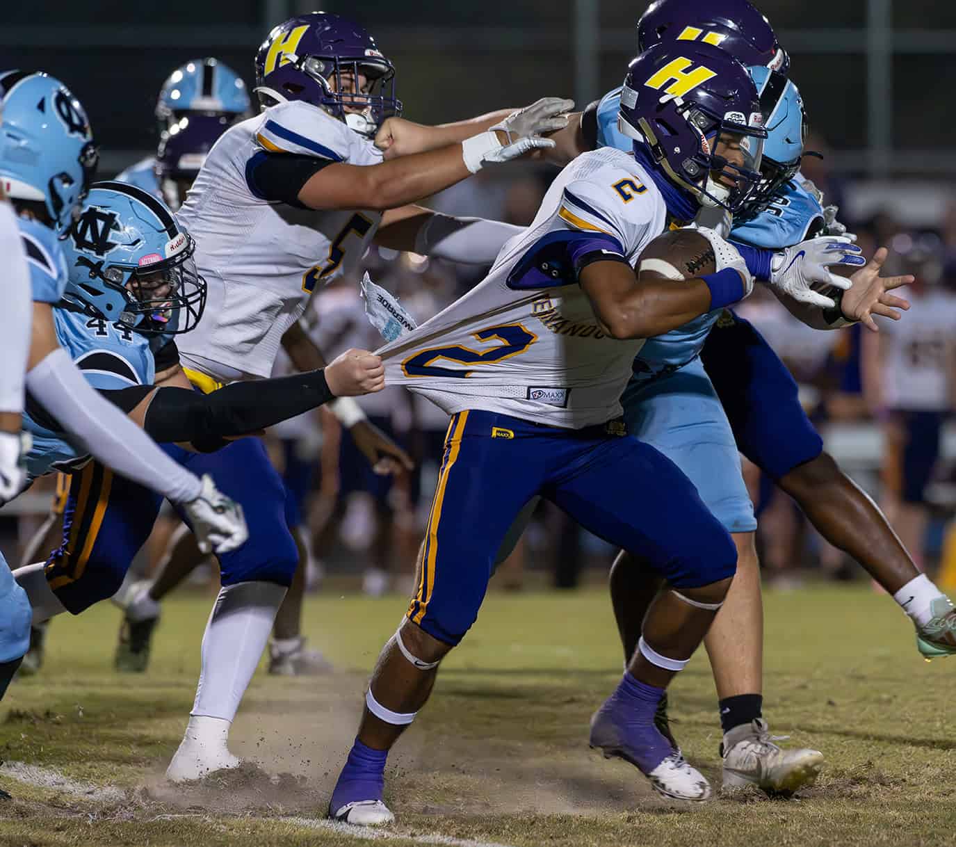 Hernando High, 2, Gabe Sansone tries to escape the grasp of Nature Coast's ,44, Brayden Hogan. [Photo by Joe DiCristofalo]