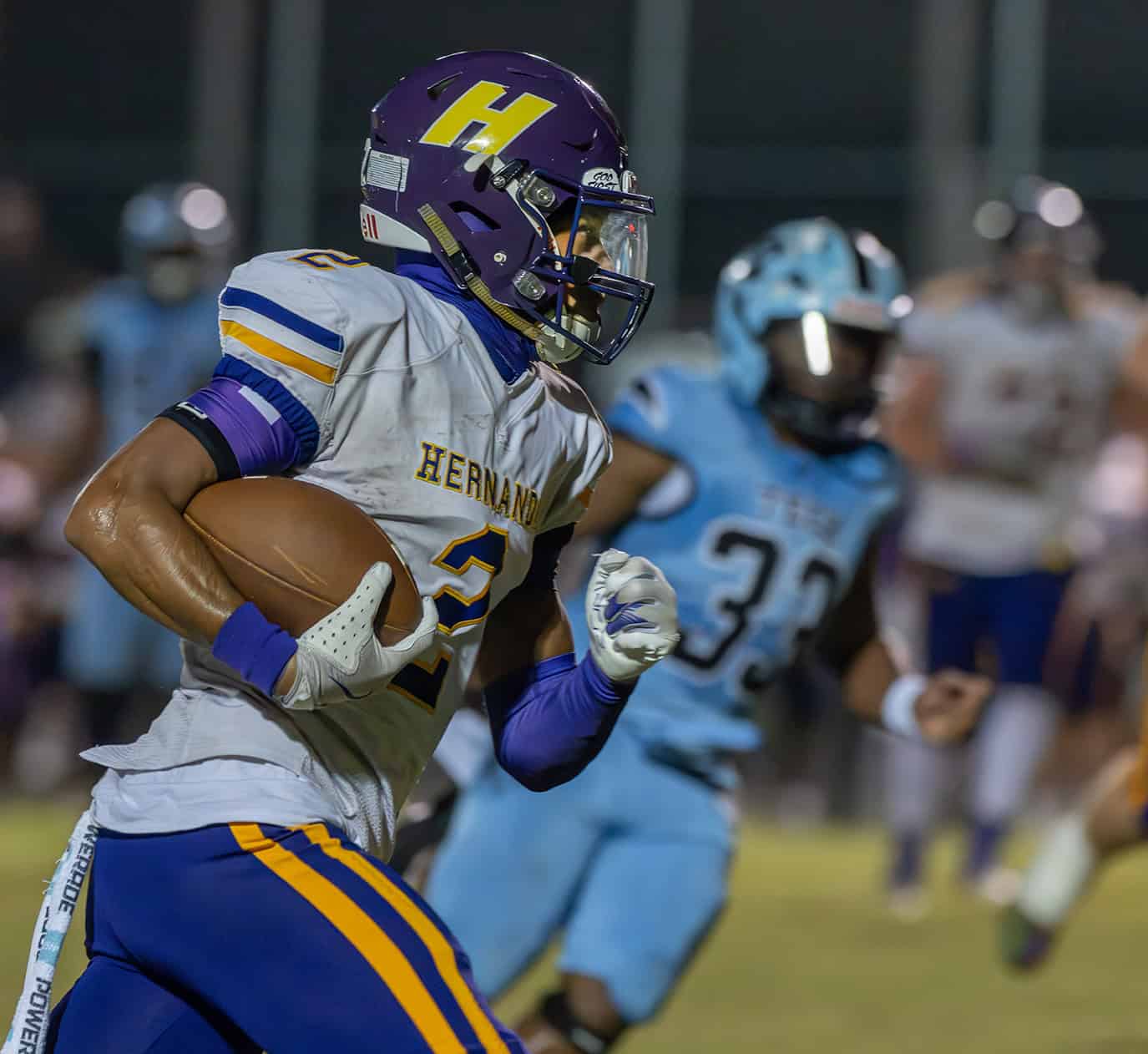 Hernando High, 2, Gabe Sansone eyes open space on a long gain versus Nature Coast. [Photo by Joe DiCristofalo]