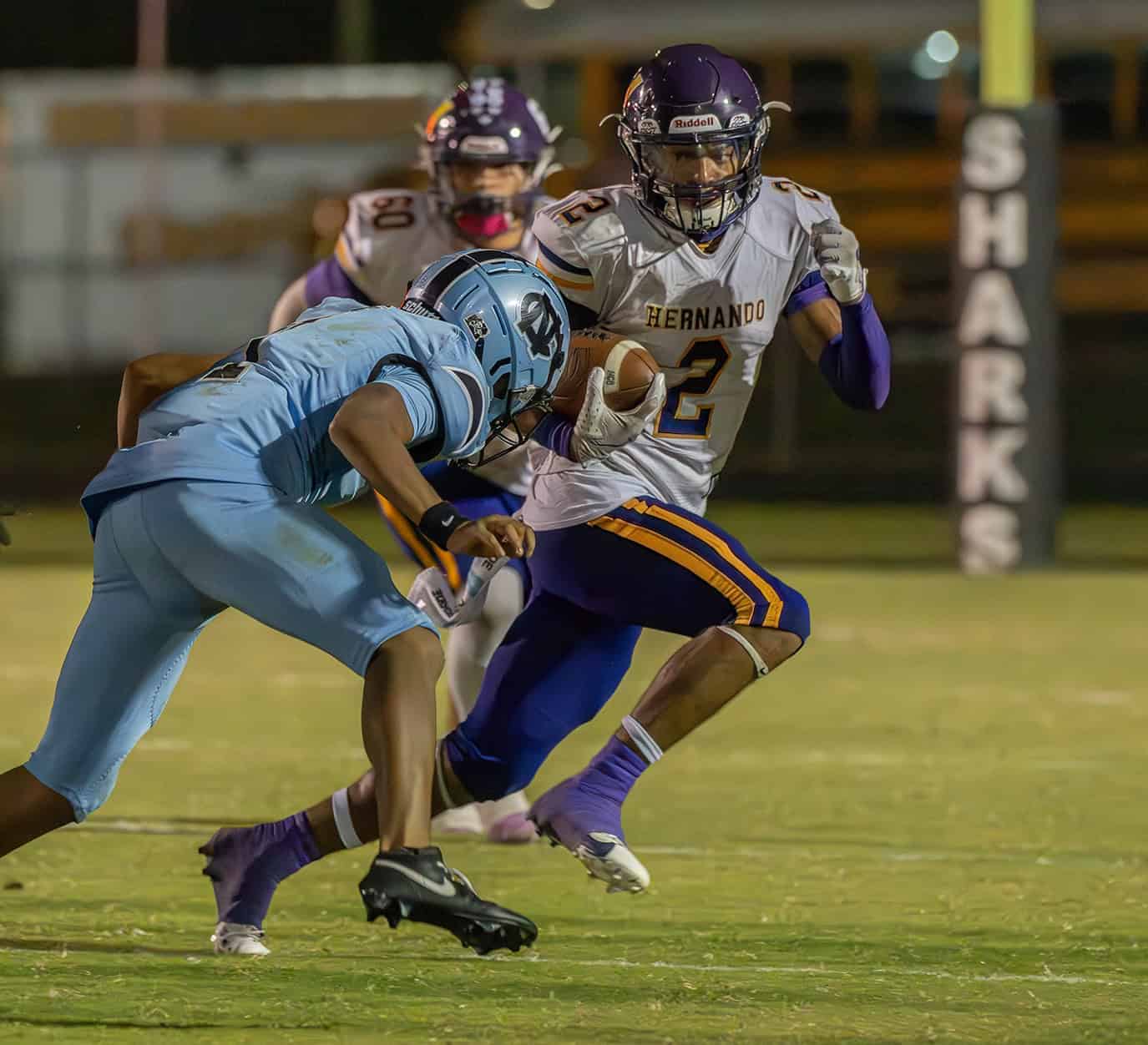 Hernando High, 2, Gabe Sansone tries to elude the tackle by Nature Coast, 1, Aveion Jackson Friday at Nature Coast Tech. [Photo by Joe DiCristofalo]