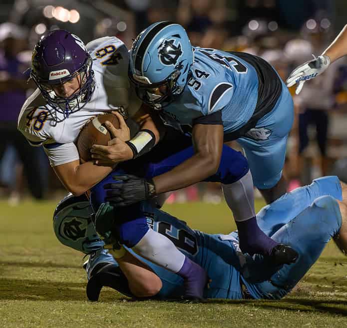 Hernando High, 48, Mason Pauliot gets taken down after a short gain in the red zone by Nature Coast Tech, 54, D'Treyvion Wilson and 6, Grant Lanning. [Photo by Joe DiCristofalo]