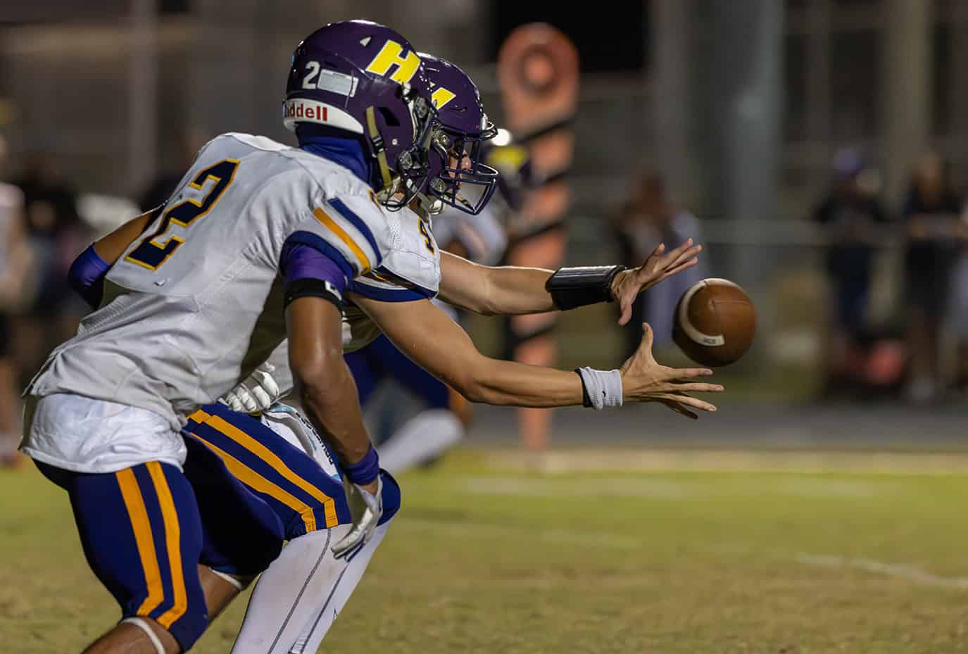 Hernando High QB, Michael Saltsman handles a shotgun snap before handing off to ,2, Gabe Sansone who took the ball 68 yards on the play. [Photo by Joe DiCristofalo]