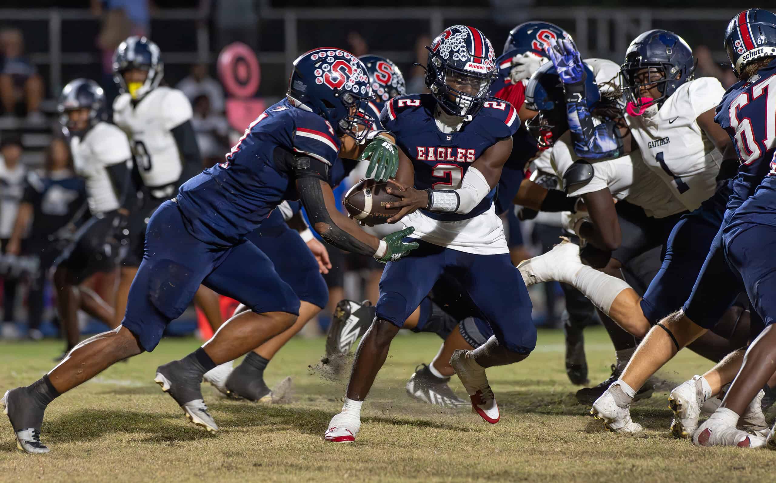 Springstead High, 2, Tyree Davis hands the ball to ,4, Connor Mccazzio Thursday at Booster Stadium in the game versus visiting Gaither High. [Photo by Joe DiCristofalo]