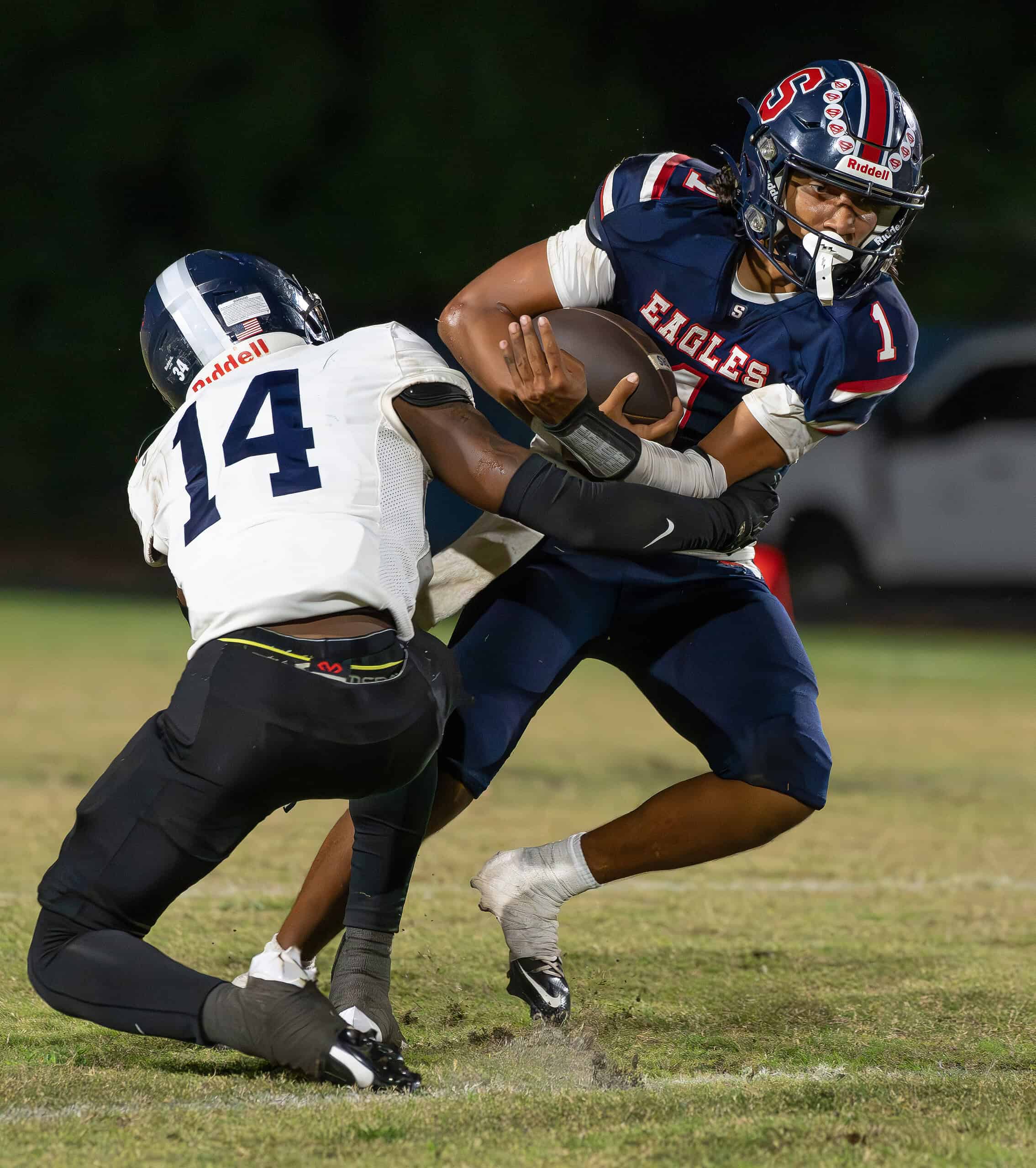 Springstead High, 1, Gio Martinez attempts to break free from Gaither High ,14, John Benson Thursday at Booster Stadium.  [Photo by Joe DiCristofalo]