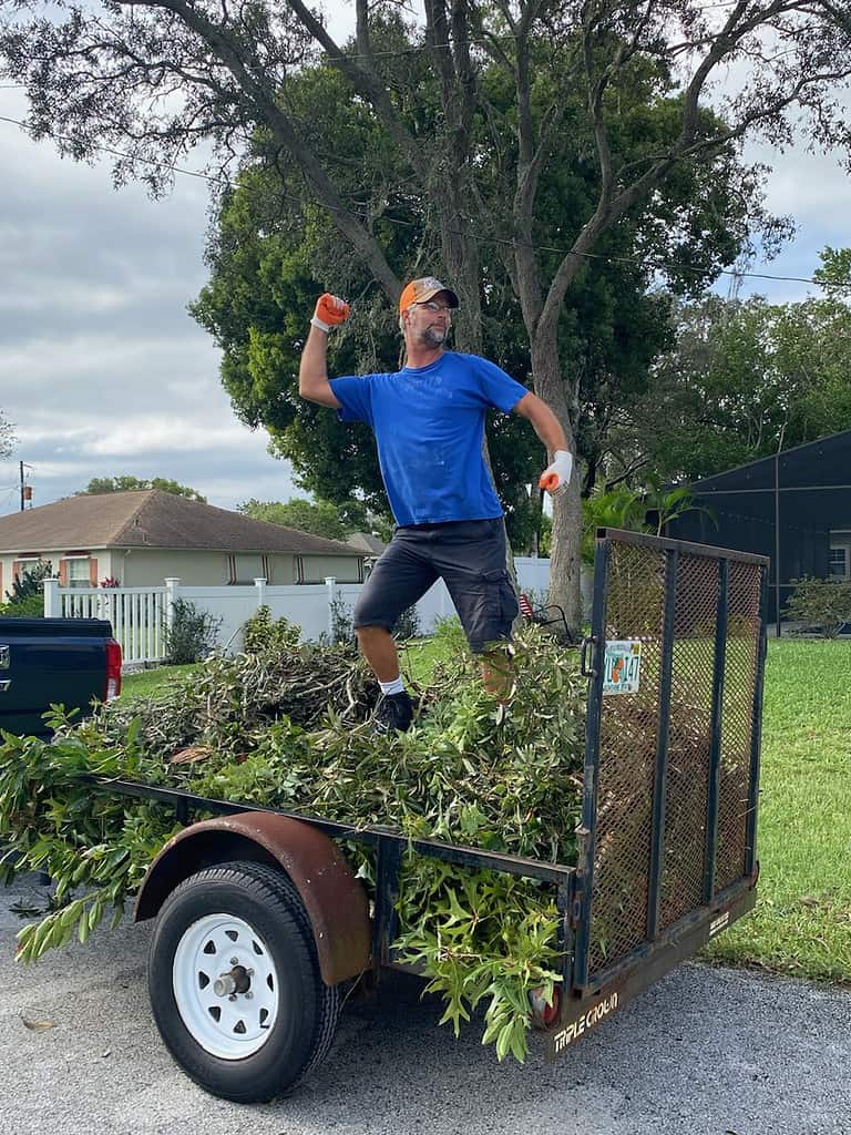 My neighbor helping clean up my debris after Milton. [Photo courtesy of Janet Hennessy]