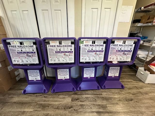 An easy-to-spot Narcan® dispenser was distributed by the Hernando Community Coalition. So far, six Narcan® dispenser stands have been situated in the county. [Photo by Sue Quigley]