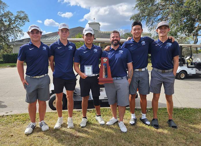 Wesley Chapel Wildcats Head Coach Josh Raskopf and the team with Tien do holding the top score trophy. [Photo Credits: Austyn Szempruch]