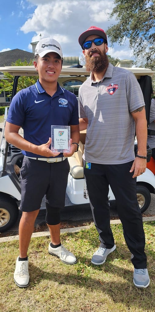 Springstead Head Coach Matt McGarry hands Wesley Chapel's Tien do the award for top score on Tuesday.