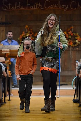 Emrie and Weston in the duo category walk the Barn runway in the Feed Bag Fashion Show at the Cowboy Festival November 16, 2024. Emrie and Weston took home first place for duos. [Photo by Jenifer Truitt]