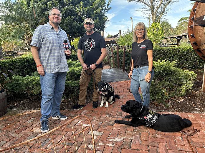 (L-R) Charley Belcher from Fox13 News; K9P4P Veteran Nick Caris and his service dog, Mika; Mary Peter and service dog, Justice [Photo courtesy of K9 Partners for Patriots]