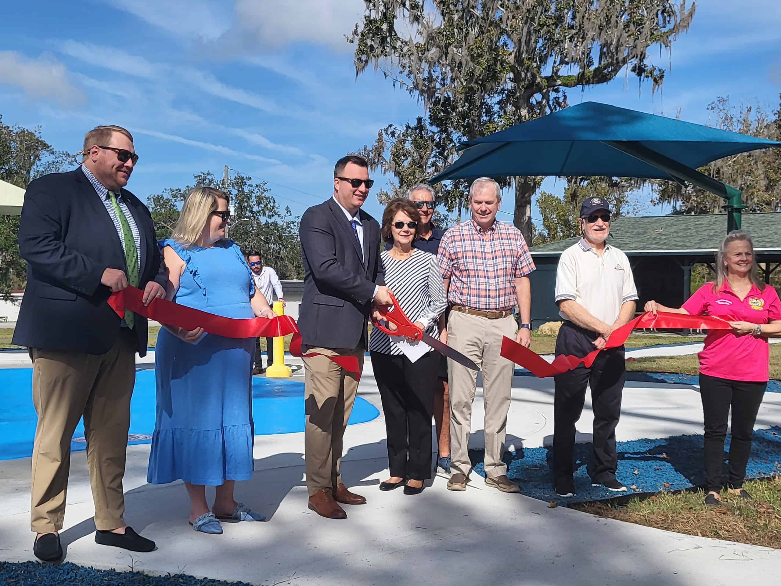 Elected officials and Kiwanis of Brooksville members cut the ribbon at the newly completed splash pad [Credit: Lisa MacNeil]