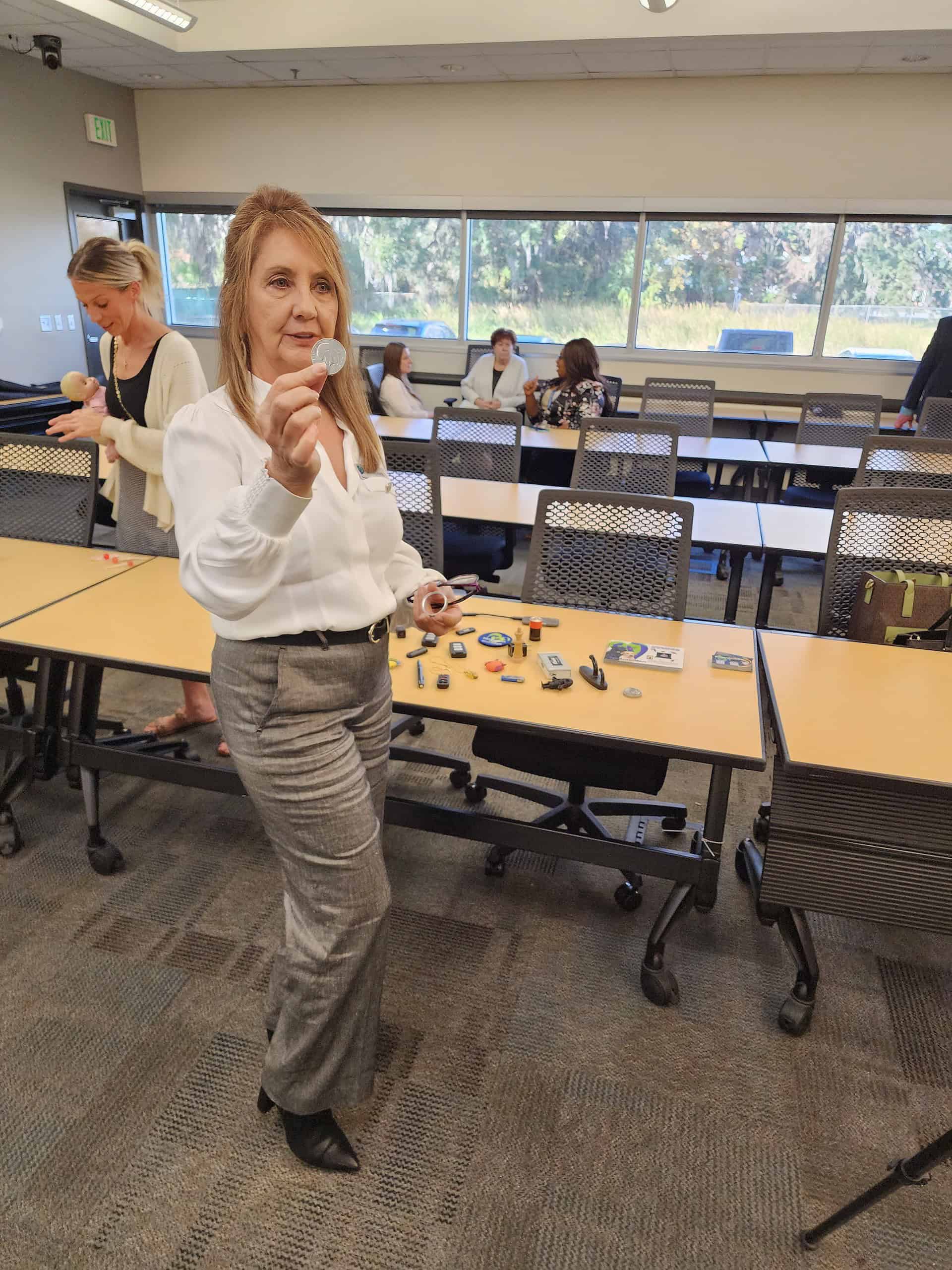 Toni Clark shows some of the unassuming devices criminals will use to record and collect illegal material. [Credit: Austyn Szempruch]