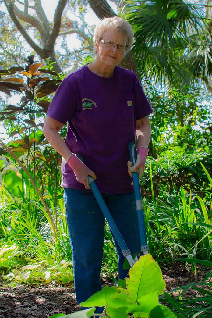 Nature Coast Botanical Gardens volunteer Mary Wuest works in The Secret Garden. [Photo by Jenifer Truitt]