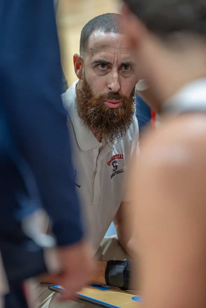 Springstead High's Head Coach, Matthew McGarry, consults with his team during a time-out during the game with visiting Mitchell High. [Photo by Joe DiCristofalo]