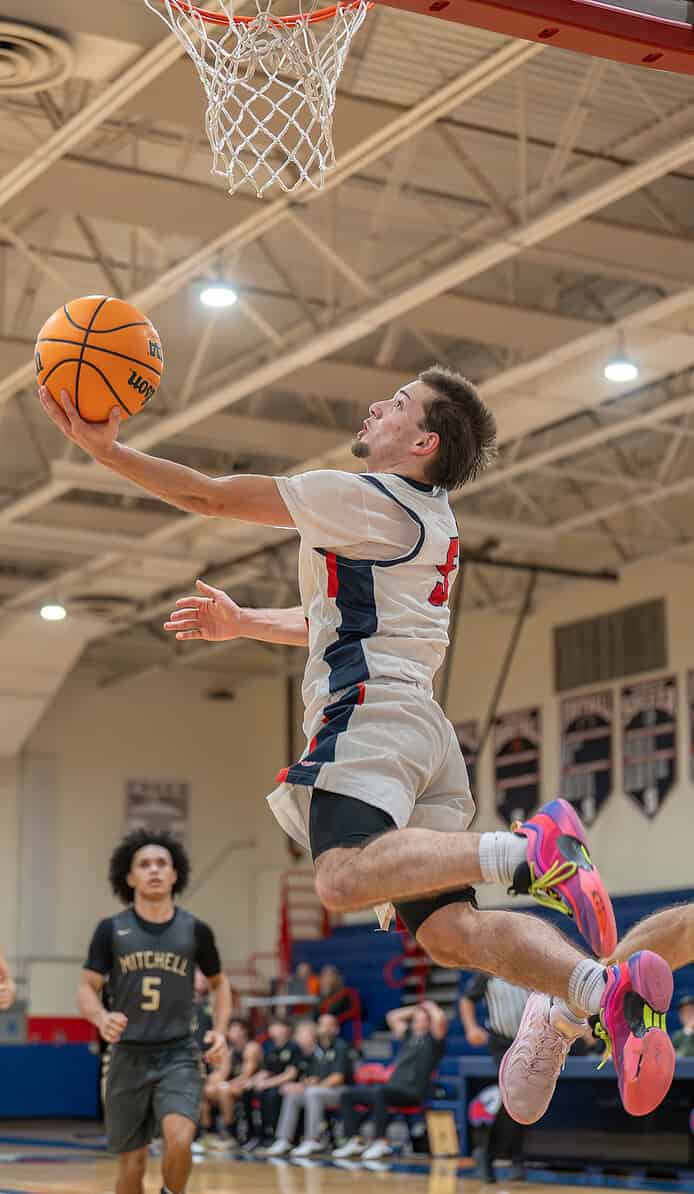 Springstead High's Ryan Sayre scored two points with an acrobatic reverse layup late in the game against visiting Mitchell High. [Photo by Joe DiCristofalo]