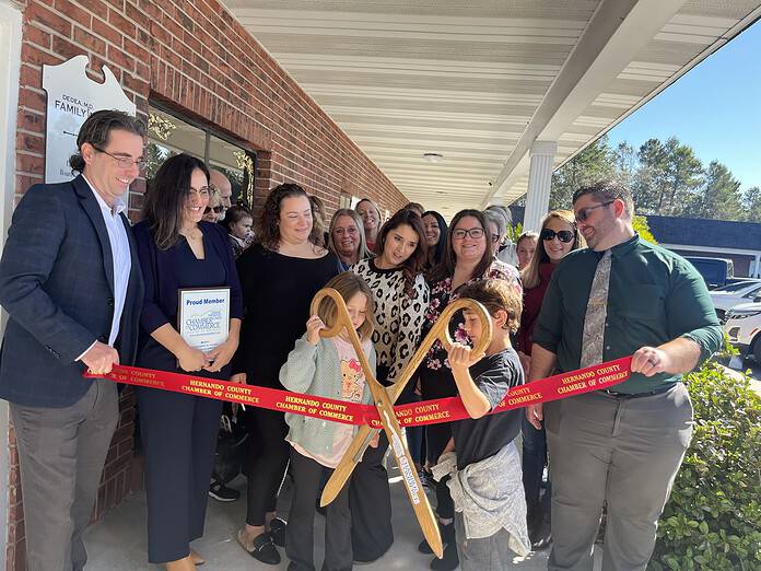 Dedea Family Medicine Grand Opening with the Chamber. The ribbon was held by Dr. Anthony Dedea and their practice manager LaVon Meritt. [Photo courtesy of Kylie Barnes]