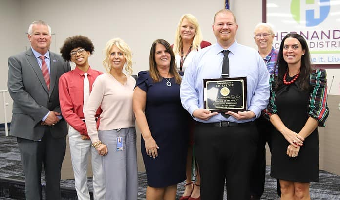 Weeki Wachee High principal Ed LaRose holds his plaque for the district's Principal of the Year, surrounded by members of the Hernando County School Board. [Credit: Hernando County School District]