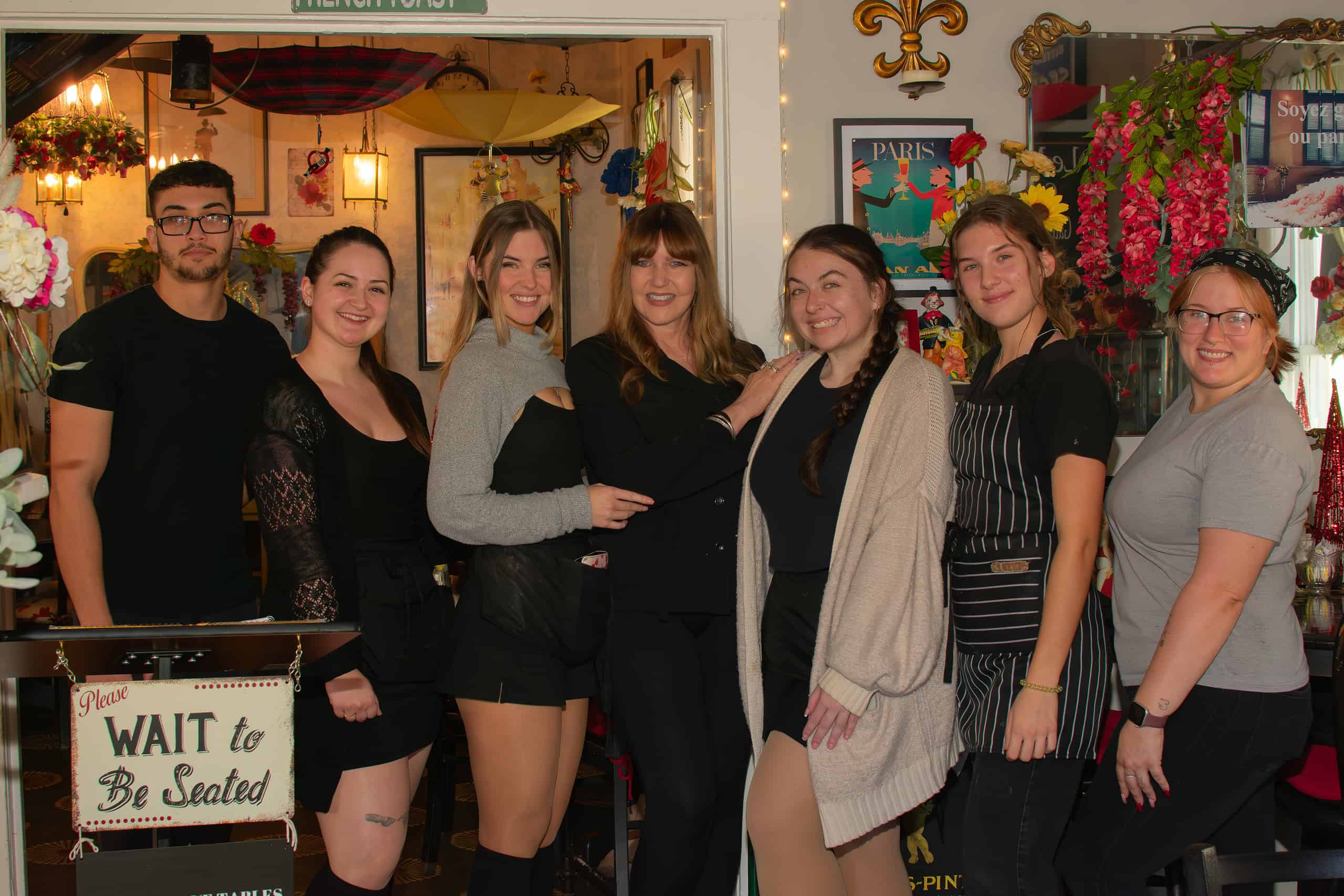 The Lazy Maid Creperie owner, Valerie Doyle (center), poses with staff during Small Business Saturday, November 30, 2024. 
[Credit: Jenifer Truitt]