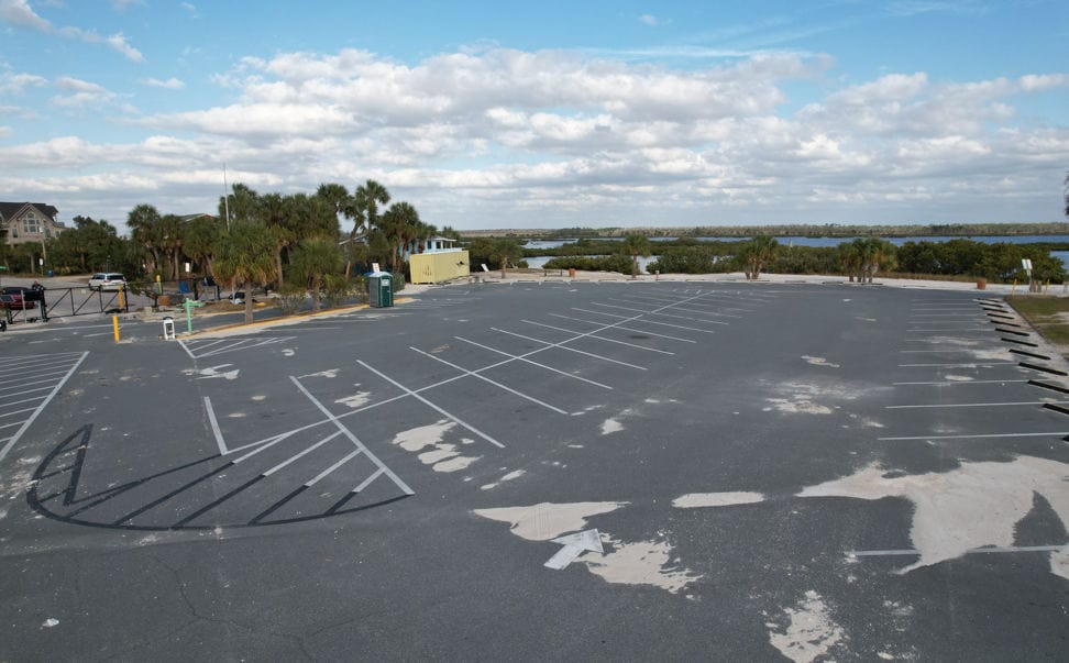 Although a bit sandy, the asphalt parking appears no worse for the wear. [Credit: Mark Stone]