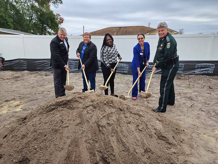 County leaders break ground with homeowner Kenya Pickering on Thursday. [Photo by Austyn Szempruch]