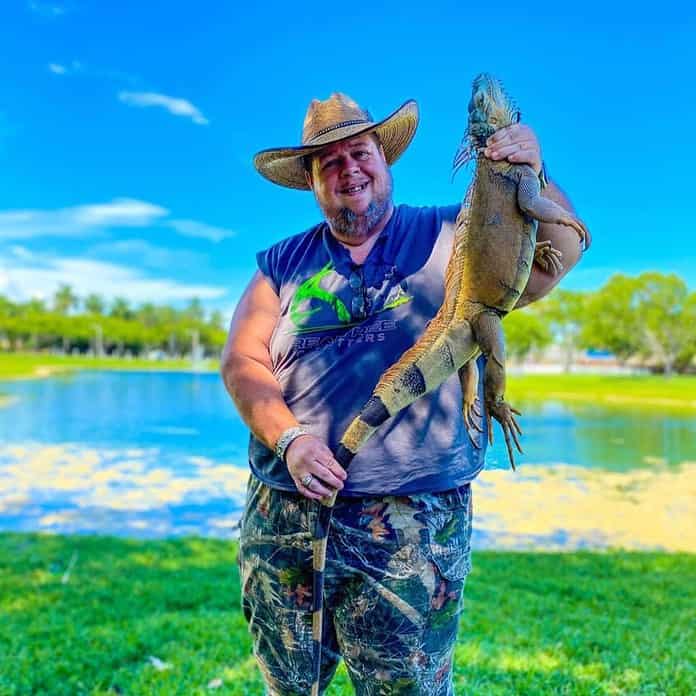 Toby with a trophy green iguana picked up on the outskirts of Miami. [Photo courtesy of Toby Benoit]