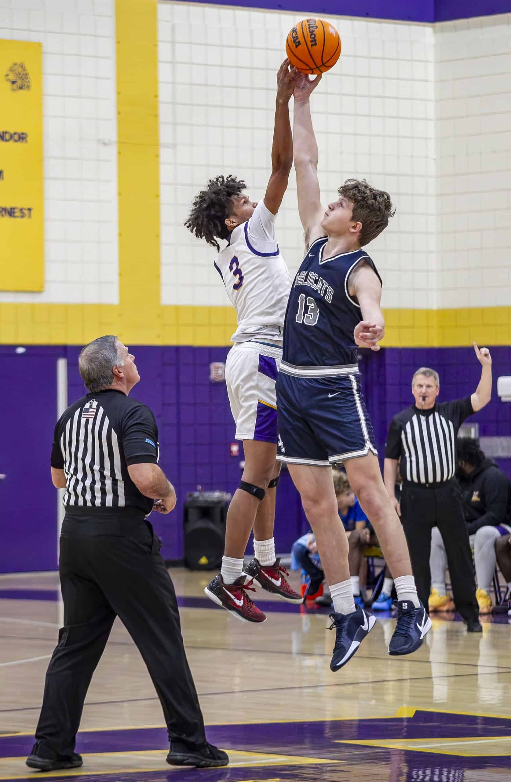 Hernando's Michael Brown, 3, and Wildcats' Tim Astapenka, 13, jump for tip-off. (Photo by Hanna Maglio)