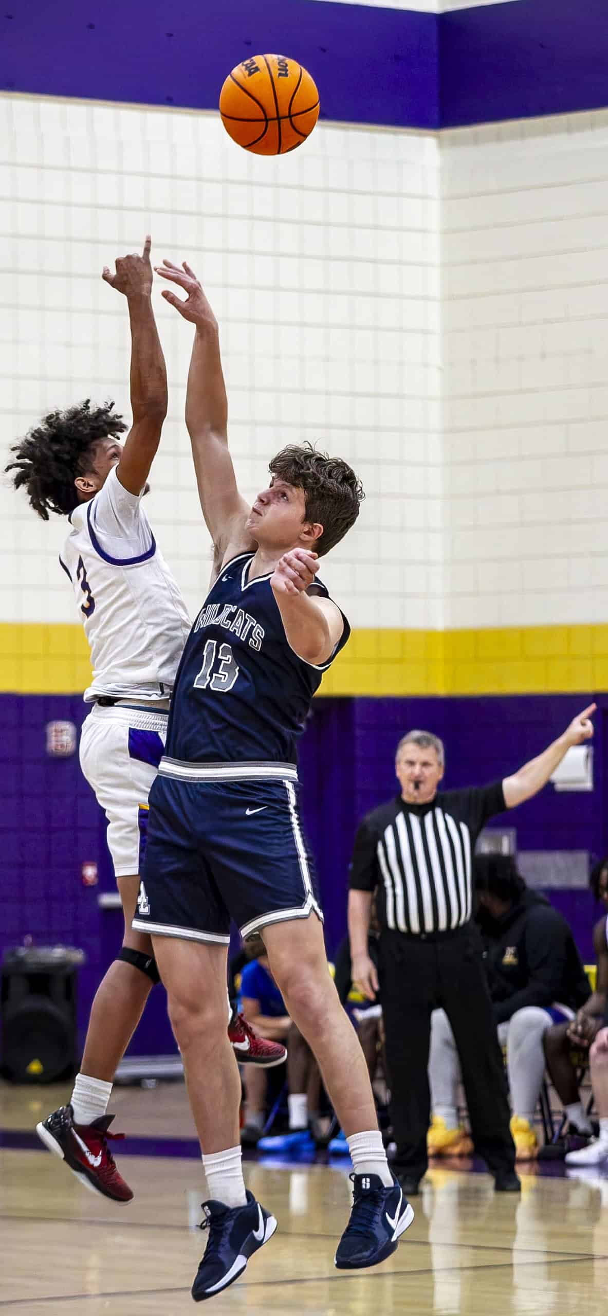 Hernando's Michael Brown, 3, and Wildcats' Tim Astapenka, 13, jump for tip-off. (Photo by Hanna Maglio)