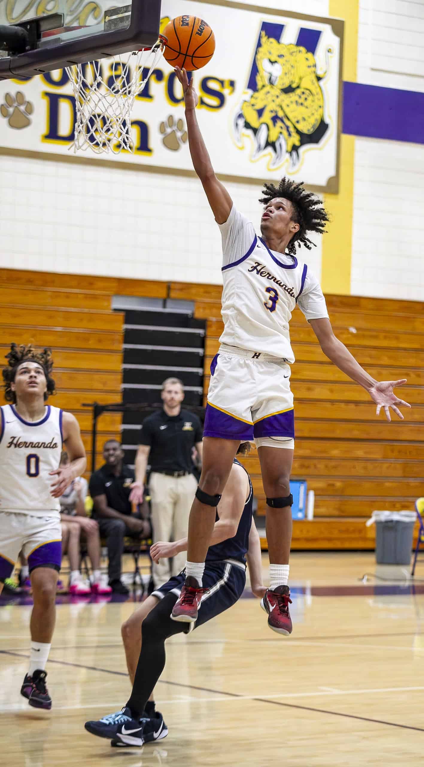 Michael Brown jumps to score a basket for Hernando. (Photo by Hanna Maglio)