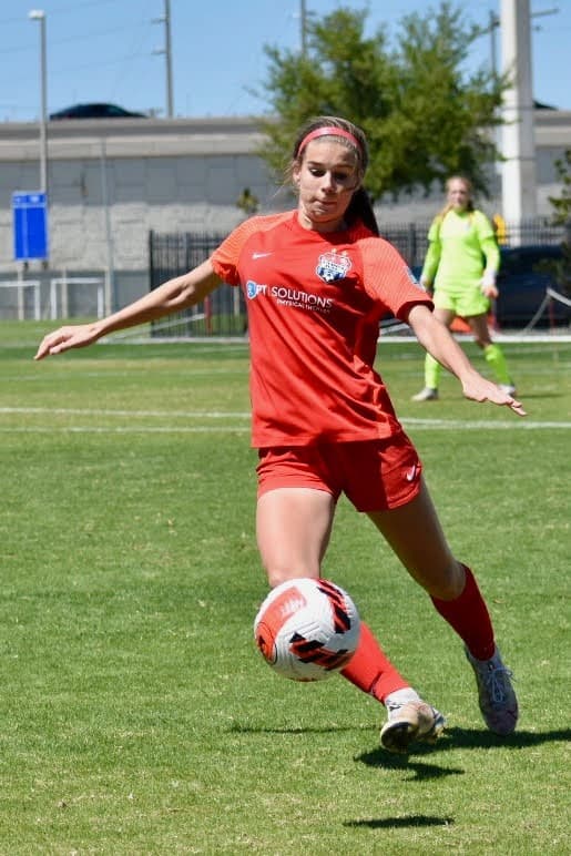 Lauren Anderson (red jersey) in action during a Tampa Bay United home game. [Credit: Jane Becker]