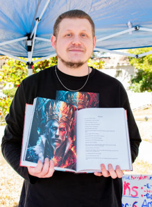 Education student and author Kenneth Lowe displays his illustrated book of poetry, Dichotomic King at Booksville on January 25, 2025. [Photo by Jenifer Truitt]