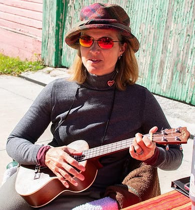 Local author Lisa Campos takes a moment to strum her ukulele at her table during Booksville on January 25, 2025. [Photo by Jenifer Truitt]