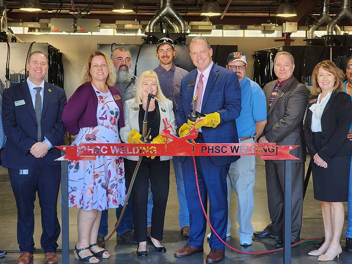 PHSC President Dr. Jesse Pisors and other administrators from the state college pose with welding torches at the Friday's ribbon cutting. [Photo by Austyn Szempruch]