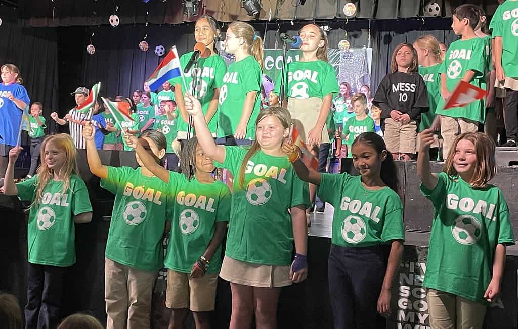 (L-R) Front row: Avaliz Uchytil, Ariella Ruiz, A'Mir LaVergne, Paisley Graves, Anabelle Cabrera, Lana Adams, Center row: Gabrielle Cordova, Peyton Knispel, Adalyn Deanet, Noah Correa (as soccer player Lionel Messi), Alexander Bozek. [Credit: Sarah Nachin]