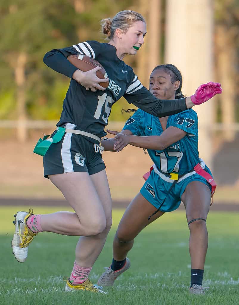 Weeki Wachee High ,15, Reese Halter tries to avoid the grasp by Sunlake High's ,17, Kaycie Hyde Thursday in Brooksville. [Photo by Joe DiCristofalo]